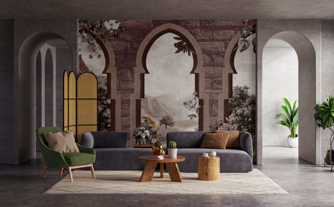 Un render della carta da parati "Archways" applicata dietro un divano in un moderno open space. Gli archi antichi e il paesaggio naturale creano un punto focale elegante e accogliente.